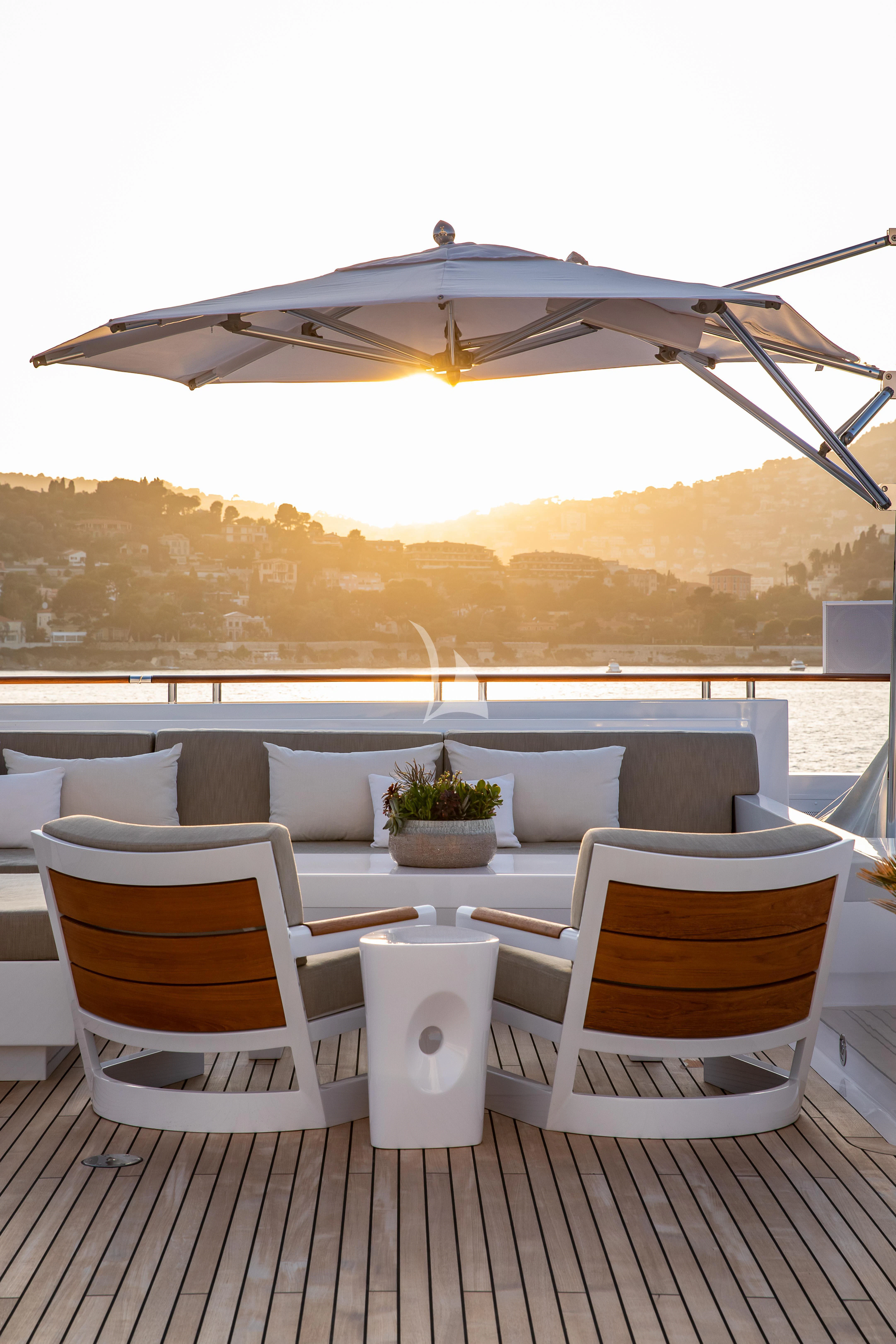 a patio with a large umbrella aboard TREEHOUSE Yacht for Sale