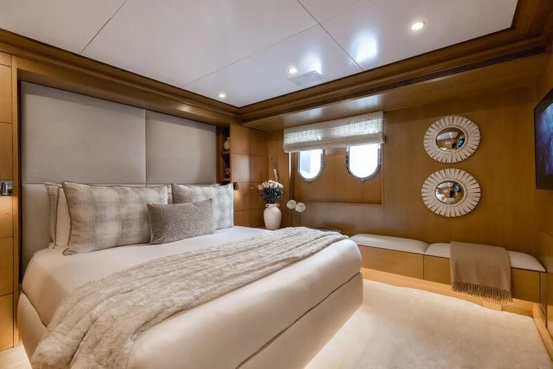 a room with a bed and a chair aboard TREEHOUSE Yacht for Sale