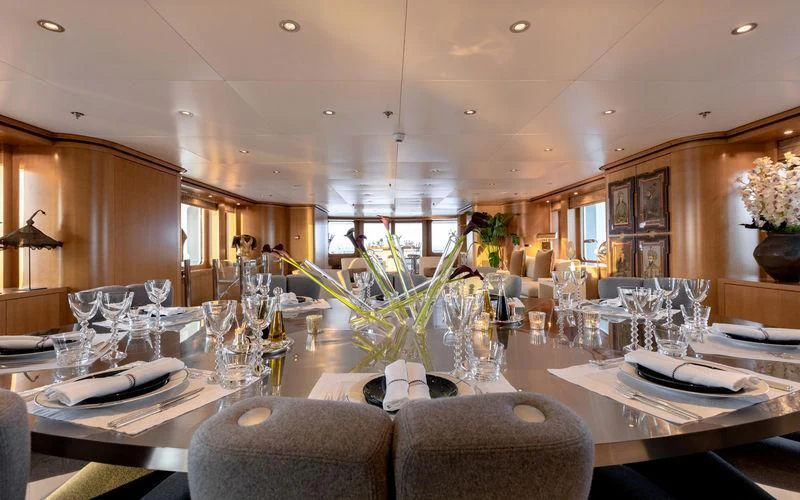 a large dining room with a chandelier aboard TREEHOUSE Yacht for Sale