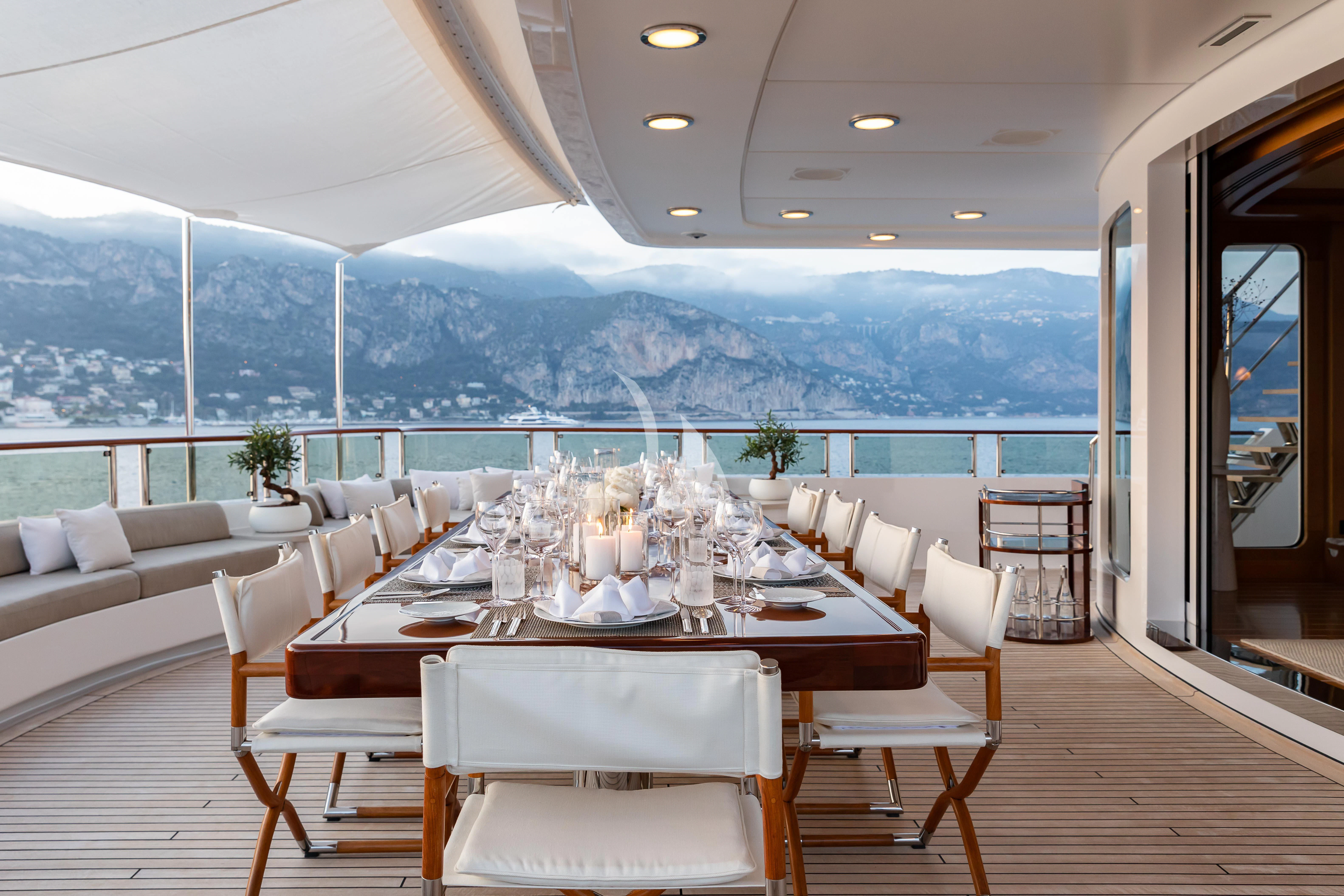 a dining room with a large table and chairs aboard TREEHOUSE Yacht for Sale