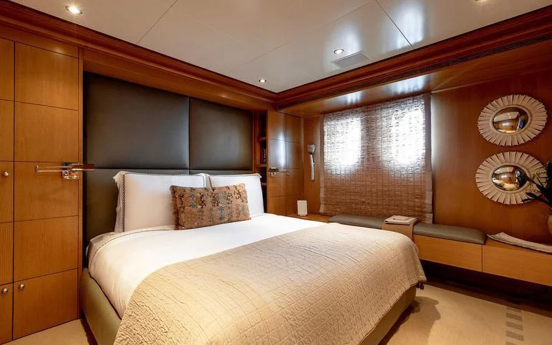 a room with a bed and a window aboard TREEHOUSE Yacht for Sale