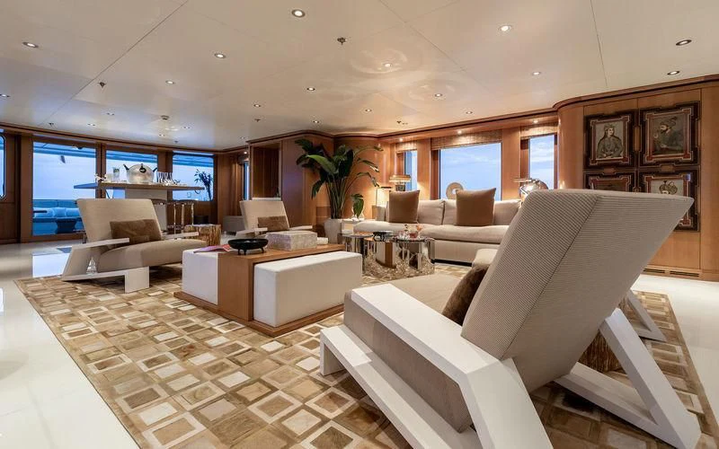 a living room with a large white couch and a large window aboard TREEHOUSE Yacht for Sale