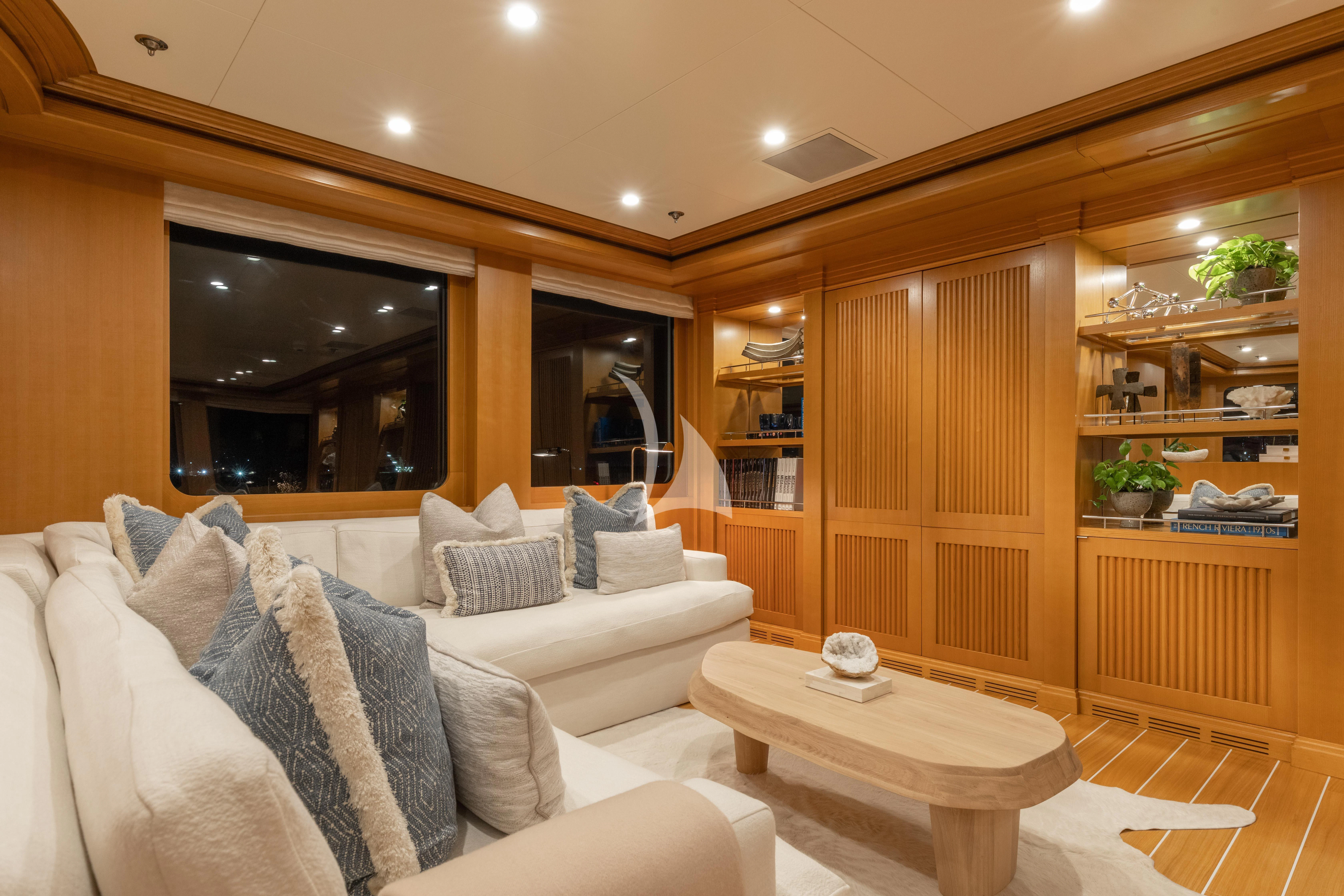 a living room with a couch and a table aboard TREEHOUSE Yacht for Sale