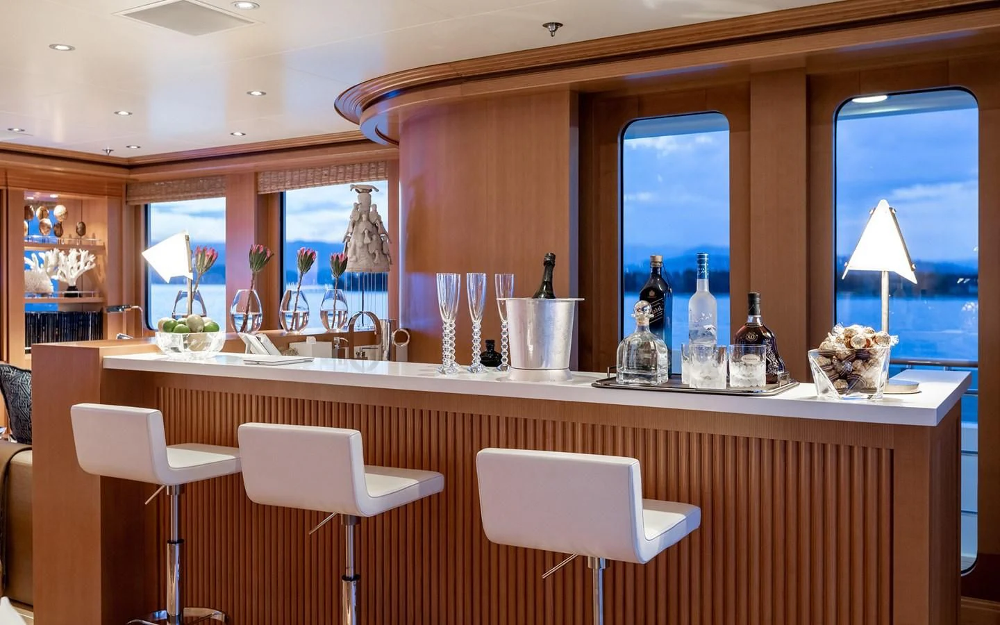 a kitchen with a counter and chairs aboard TREEHOUSE Yacht for Sale
