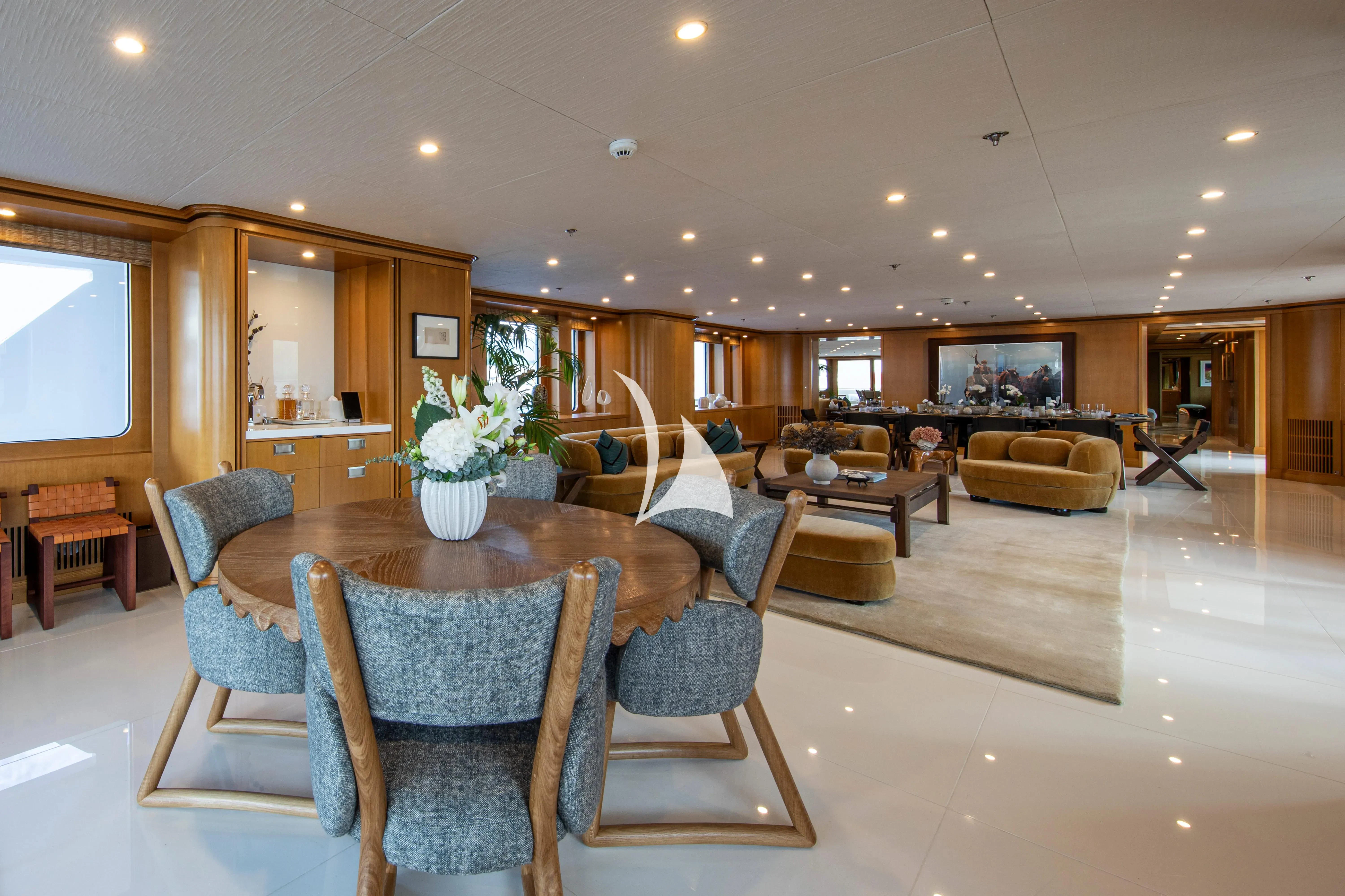 a living room with a table and chairs aboard TREEHOUSE Yacht for Sale