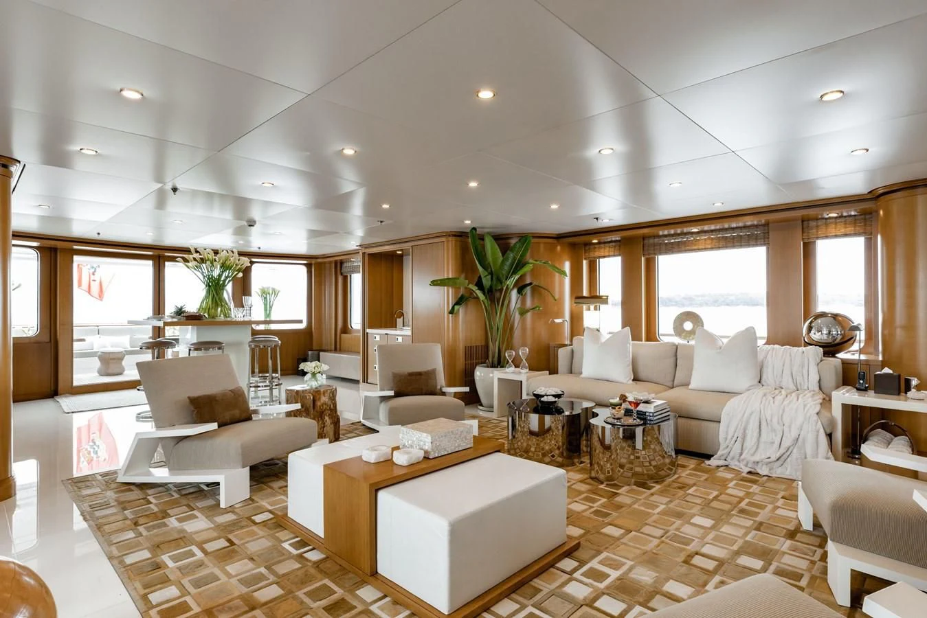 a living room with a large white sofa and a table aboard TREEHOUSE Yacht for Sale