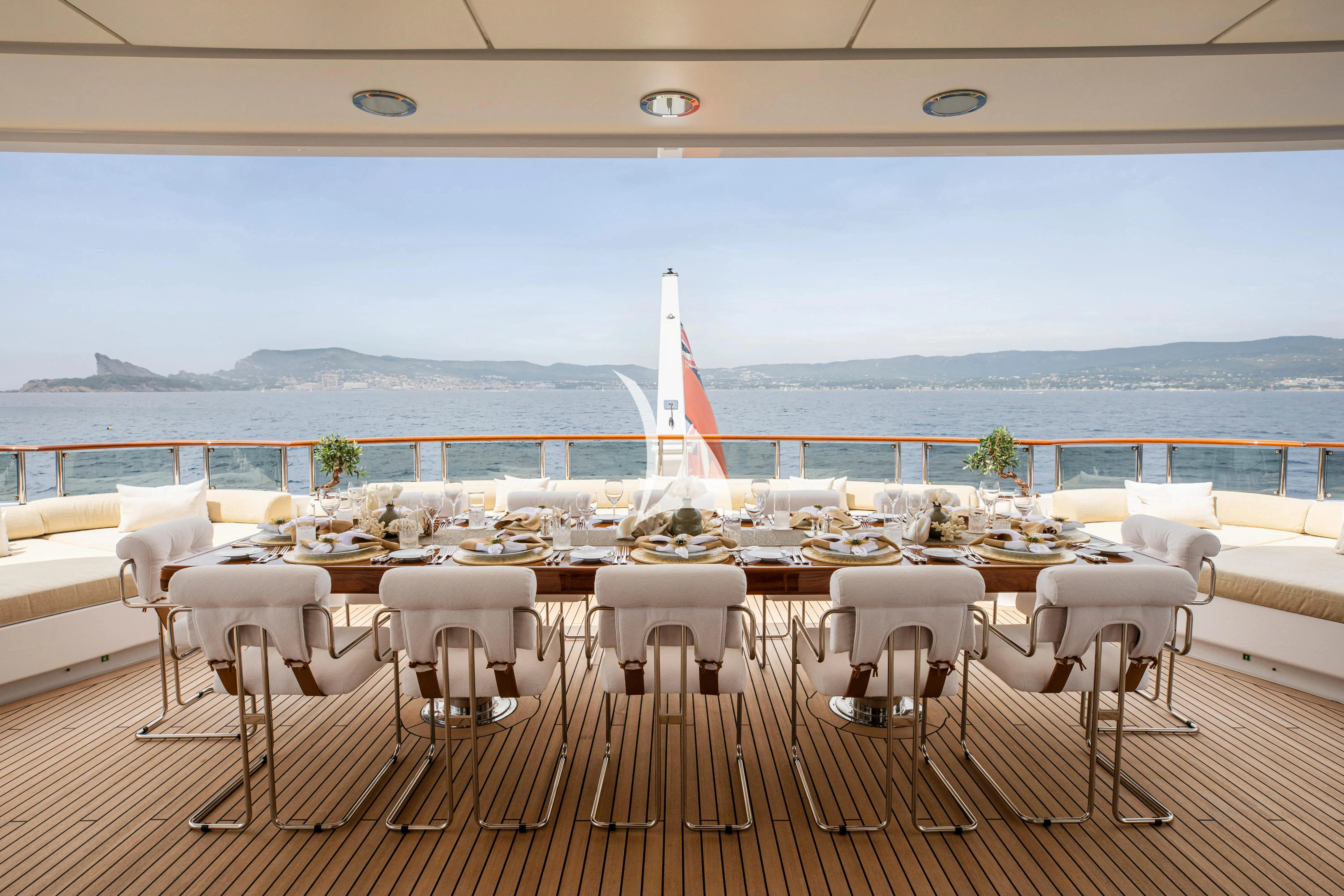a room with tables and chairs and a view of the city aboard TREEHOUSE Yacht for Sale