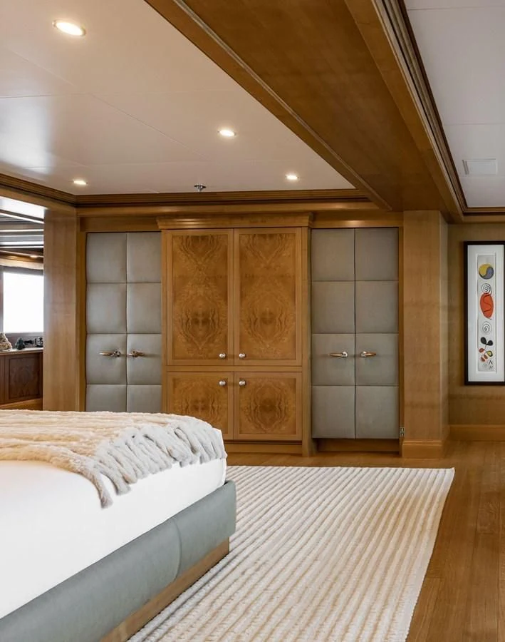 a room with a bed and a closet aboard TREEHOUSE Yacht for Sale