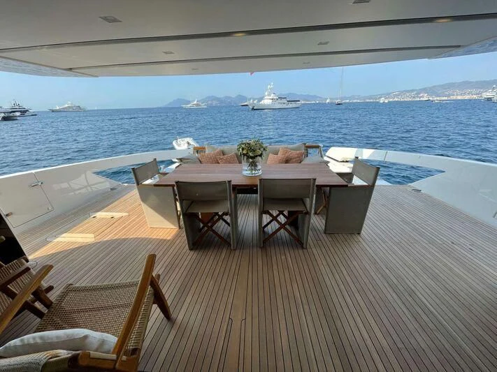 a table set for a meal on a deck overlooking the ocean aboard SPARTAN TIME Yacht for Sale