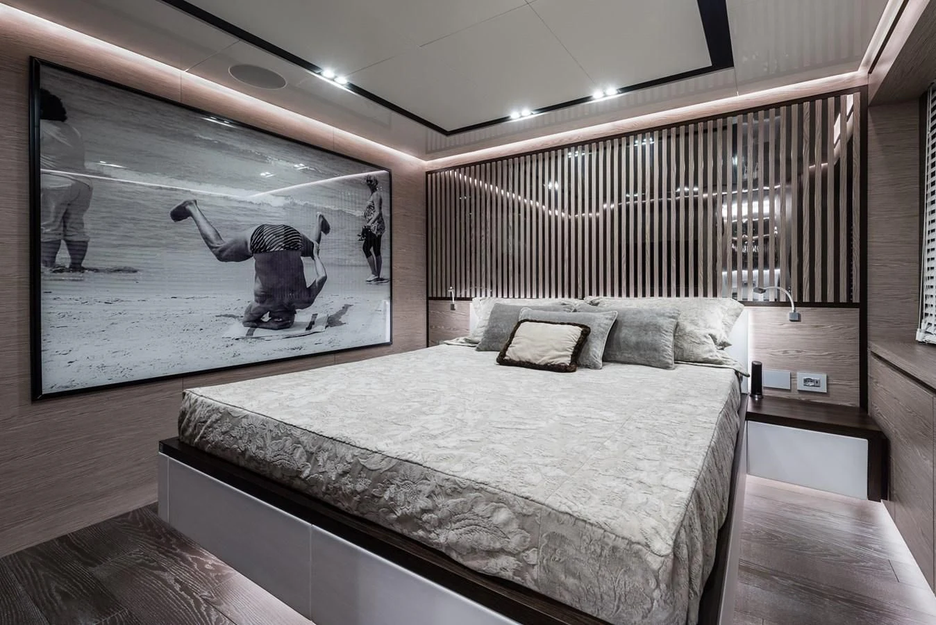 a large room with a bed and a large screen aboard ZOUT Yacht for Sale