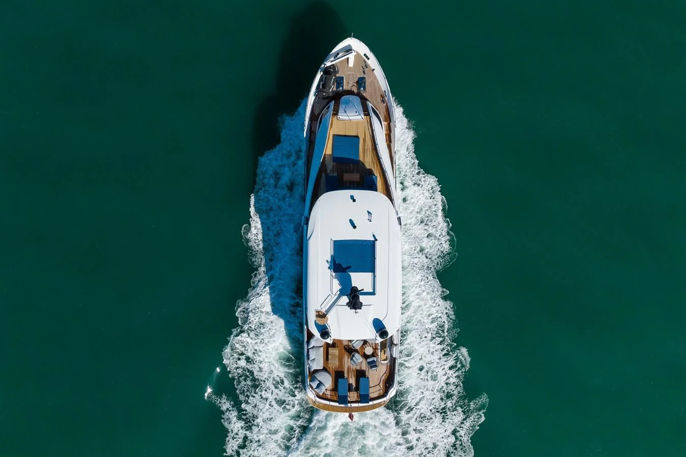 a white boat with a clock on it aboard ZOUT Yacht for Sale