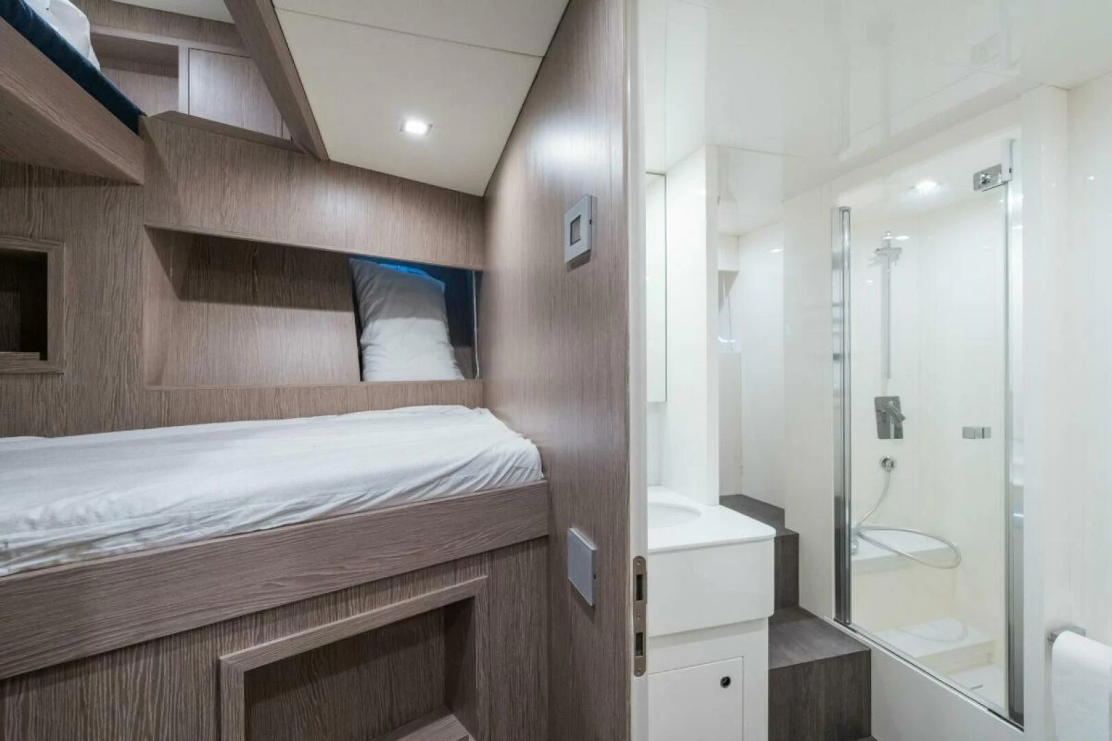 a bedroom with a bed and a mirror aboard ZOUT Yacht for Sale