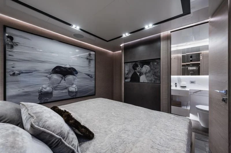 a bedroom with a bed and a mirror aboard ZOUT Yacht for Sale