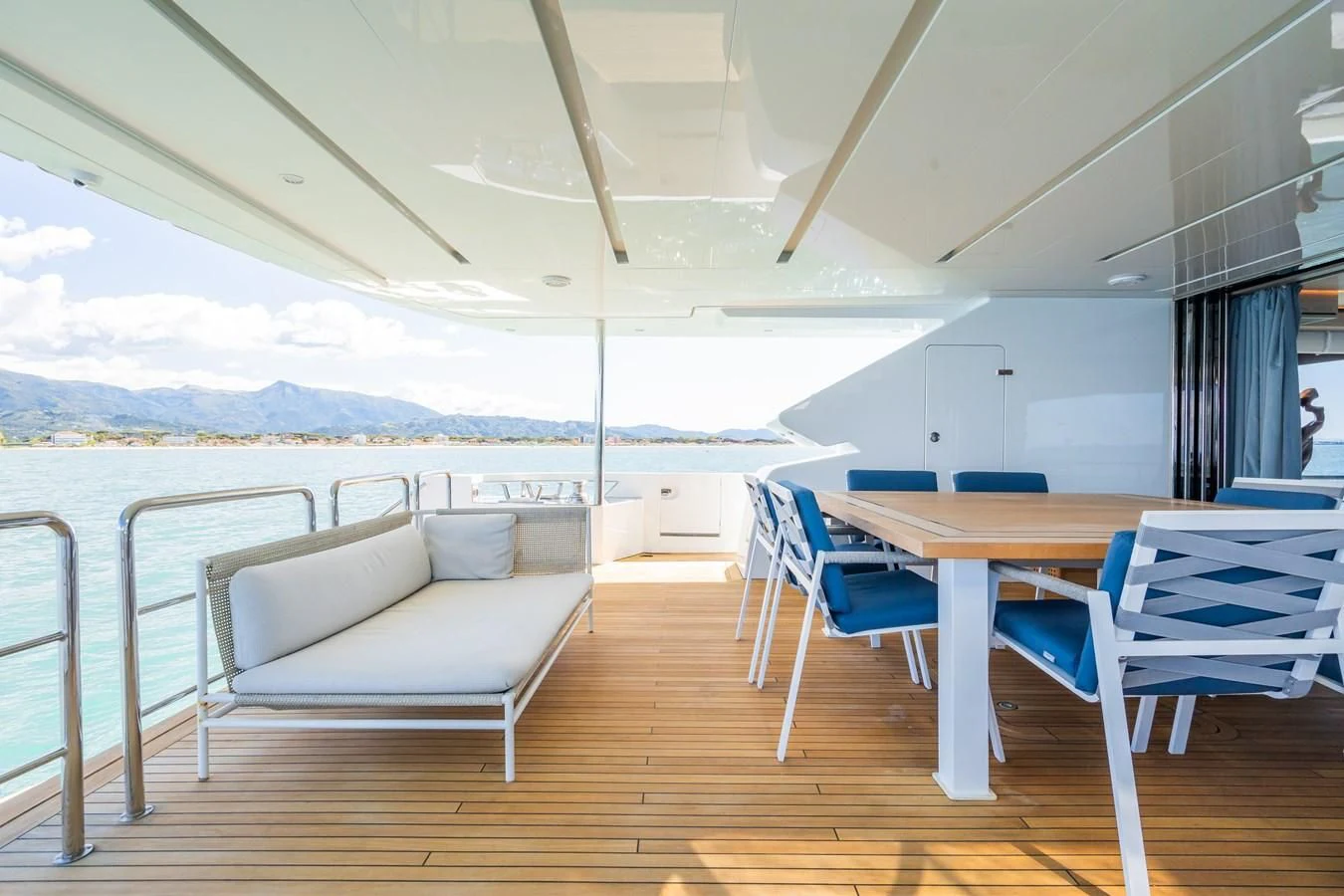 a deck with a table and chairs aboard ZOUT Yacht for Sale
