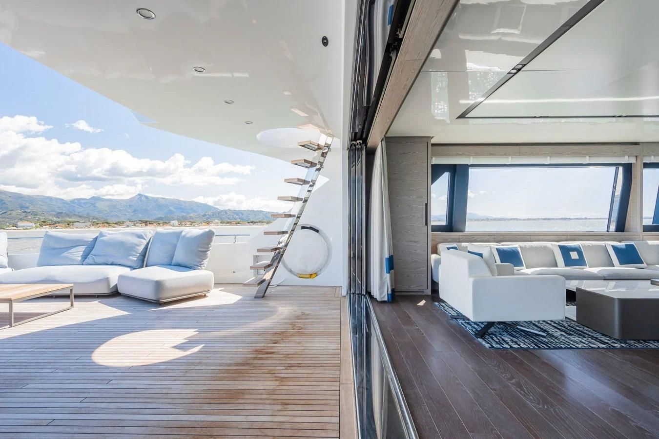 a room with a large window and a view of the mountains aboard ZOUT Yacht for Sale