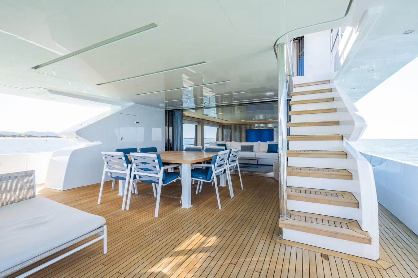 a room with a staircase and tables aboard ZOUT Yacht for Sale