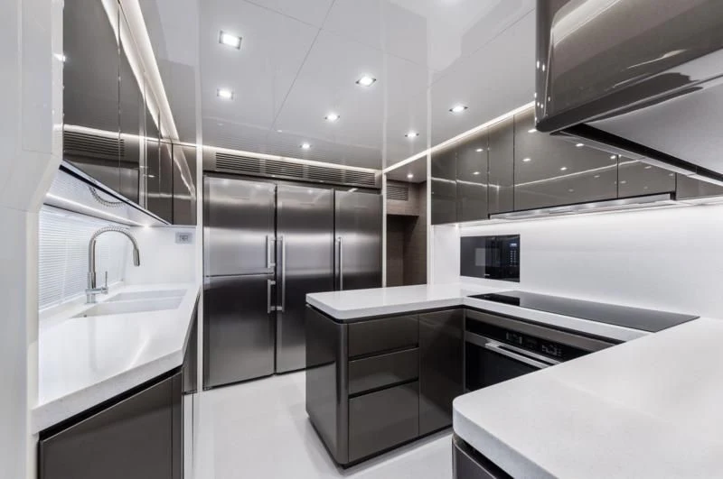 a kitchen with a sink and refrigerator aboard ZOUT Yacht for Sale