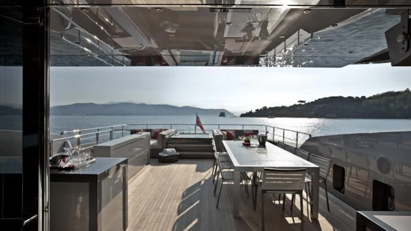 a deck with a table and chairs aboard ASTERI Yacht for Sale