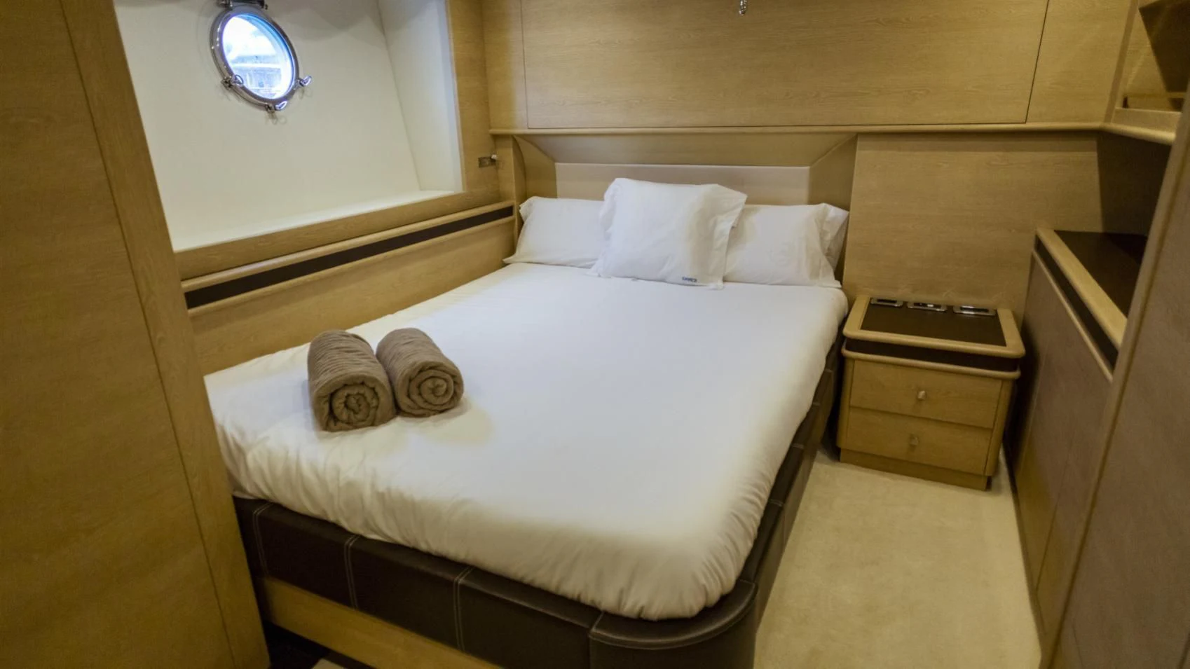 a bed with white sheets aboard ASTERI Yacht for Sale