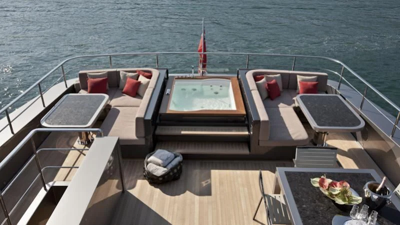 a deck with a table and chairs on it aboard ASTERI Yacht for Sale