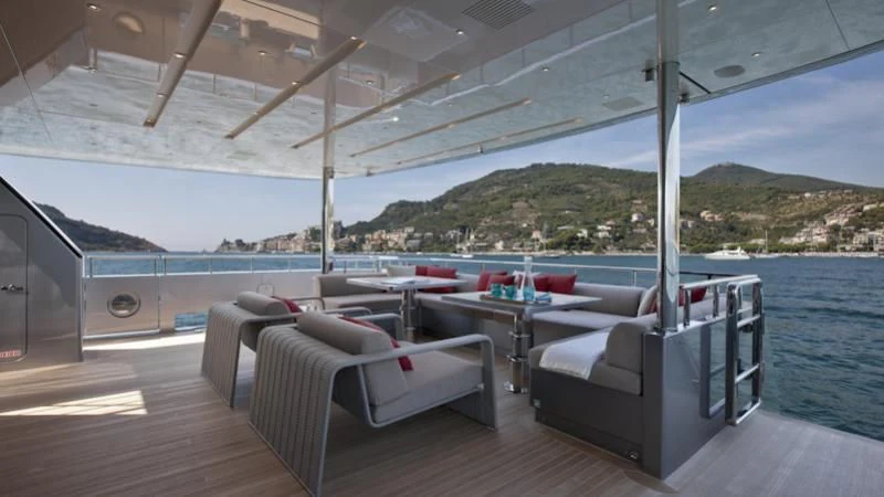 a deck with a table and chairs aboard ASTERI Yacht for Sale