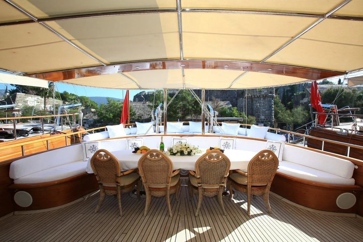 a room with a table and chairs aboard KAYA GUNERI V Yacht for Sale