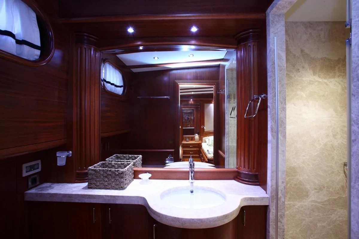 a bathroom with a large mirror aboard KAYA GUNERI V Yacht for Sale