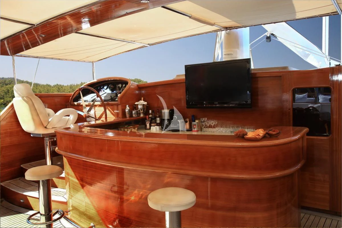 a bar with a bar and a television on the top aboard KAYA GUNERI V Yacht for Sale
