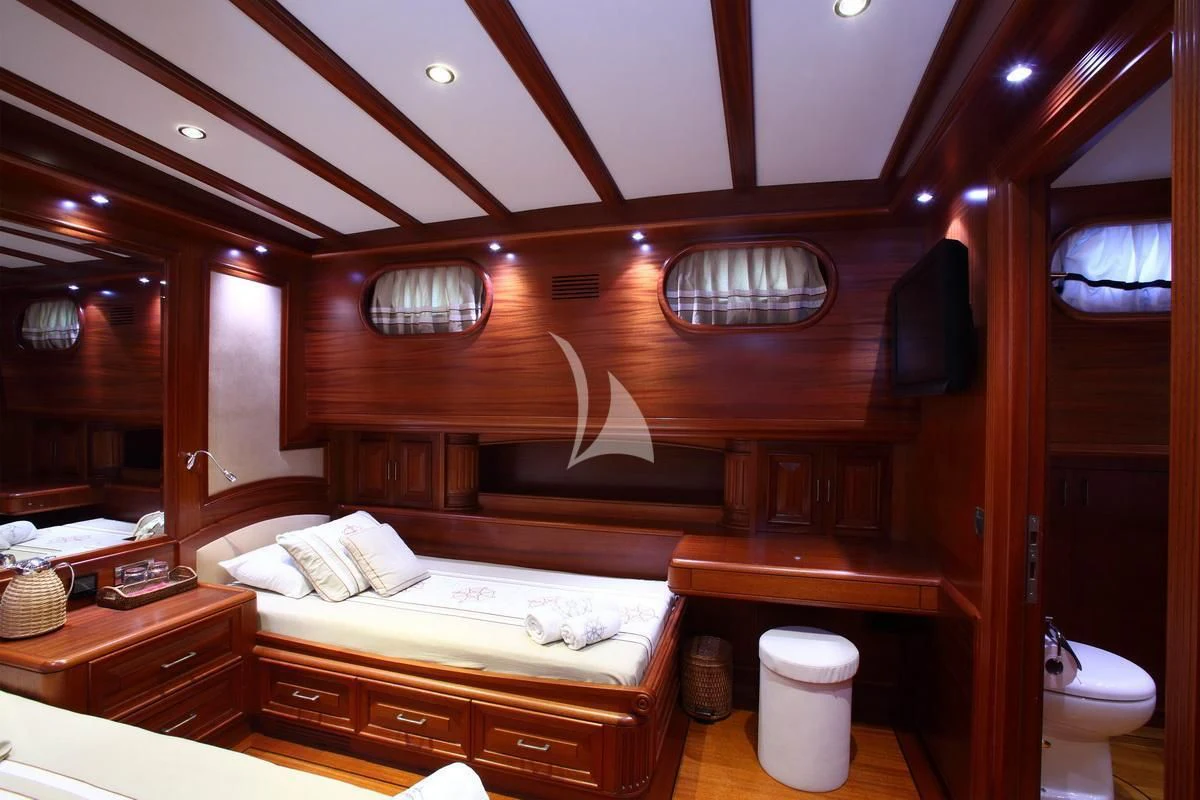 a room with a bed and a mirror aboard KAYA GUNERI V Yacht for Sale