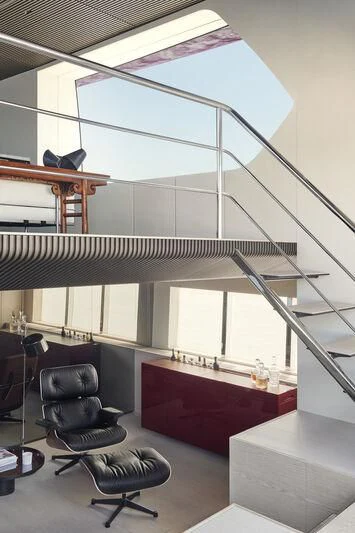 a room with a red table and chairs and a black chair aboard STEEL IT Yacht for Sale