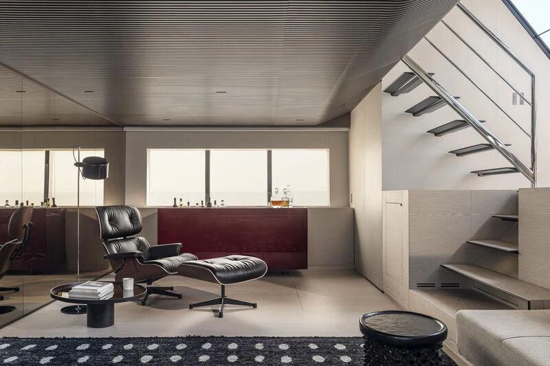 a room with a couch and a table aboard STEEL IT Yacht for Sale