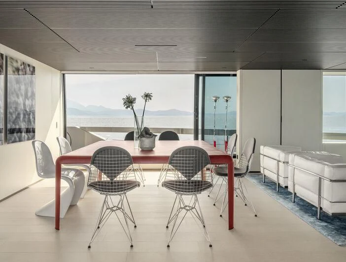 a room with tables and chairs aboard STEEL IT Yacht for Sale