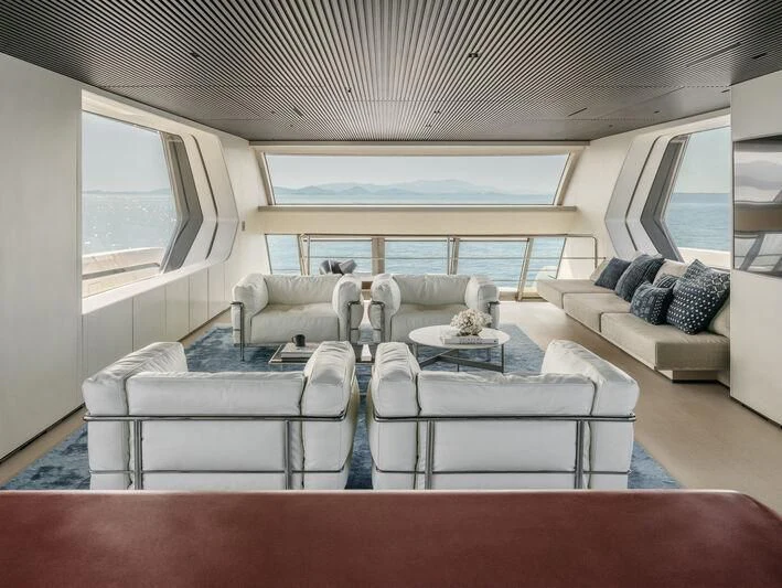 a living room with a couch and a table aboard STEEL IT Yacht for Sale