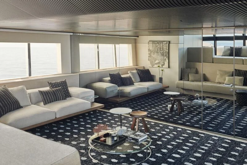 a living room with a black and white rug aboard STEEL IT Yacht for Sale