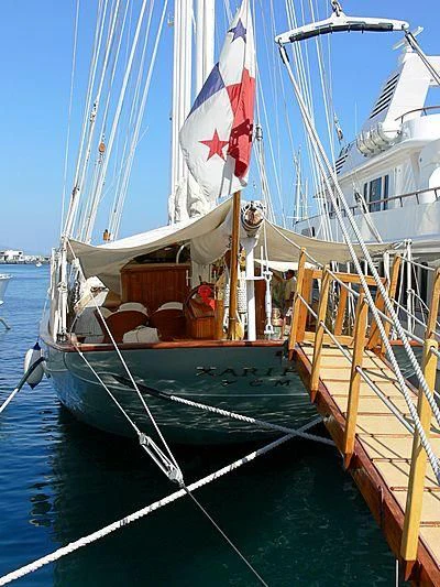a boat with a flag on the front aboard XARIFA 1927 Yacht for Sale