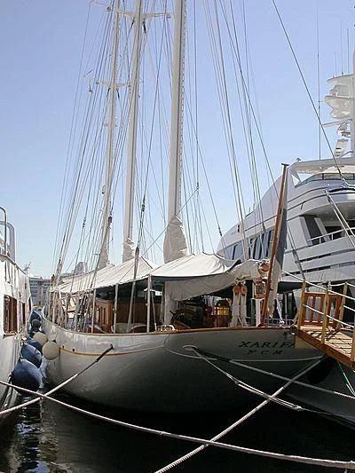 a boat docked at a pier aboard XARIFA 1927 Yacht for Sale