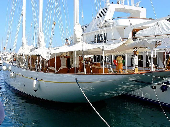 a white boat with a white canopy aboard XARIFA 1927 Yacht for Sale