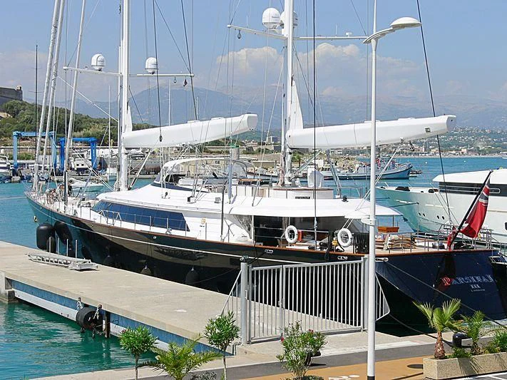 a large white boat in a harbor aboard PARSIFAL III Yacht for Charter
