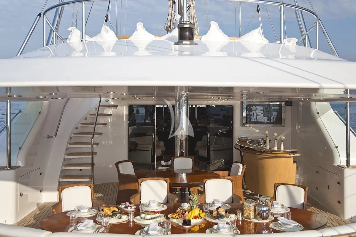 a large room with a table and chairs and a large white tent aboard PARSIFAL III Yacht for Charter