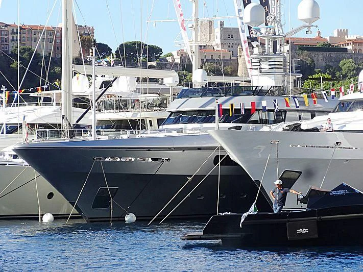 a large white boat with a person standing on it aboard MY FAIR LADY Yacht for Sale
