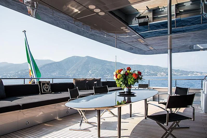 a table and chairs on a deck aboard MY FAIR LADY Yacht for Sale