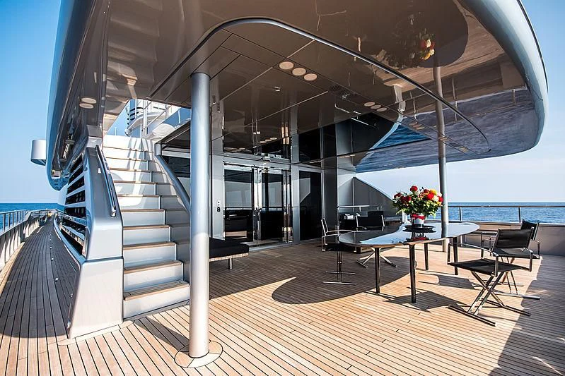 a large open space with a wood floor and a large white staircase aboard MY FAIR LADY Yacht for Sale