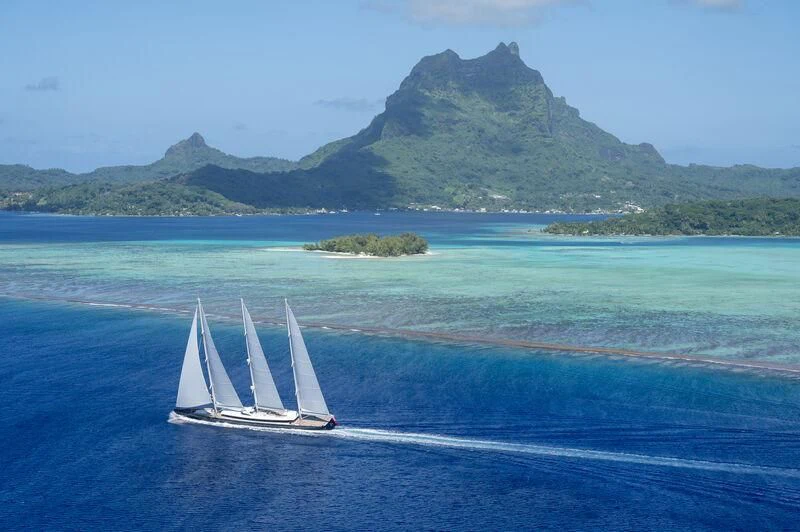a small white boat in the water aboard SEA EAGLE Yacht for Sale