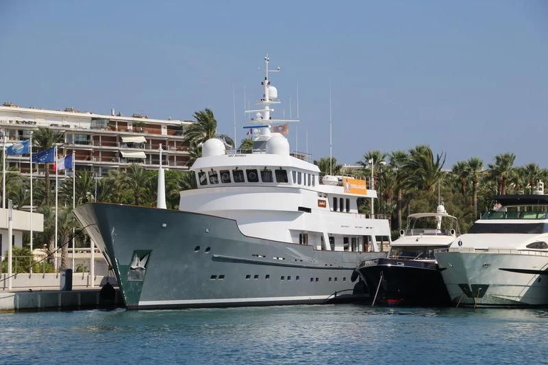 a large white boat sits at a dock aboard SEA EAGLE Yacht for Sale