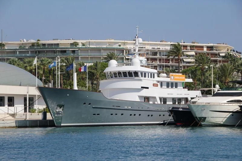 a large white boat in a harbor aboard SEA EAGLE Yacht for Sale