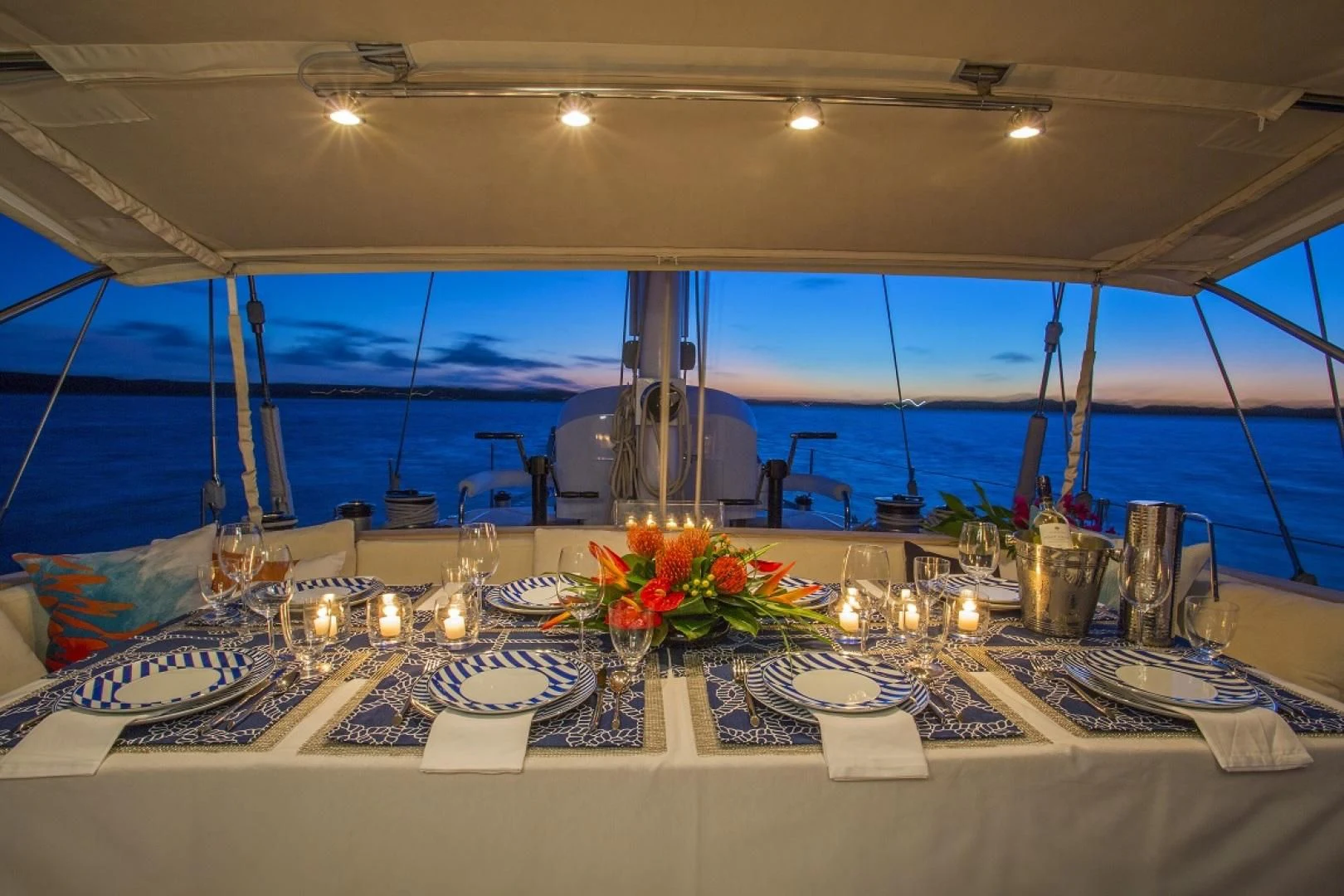a table with plates and glasses aboard WISDOM Yacht for Sale