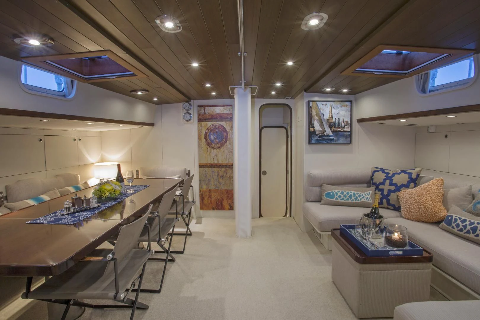 a large room with a table and couches aboard WISDOM Yacht for Sale