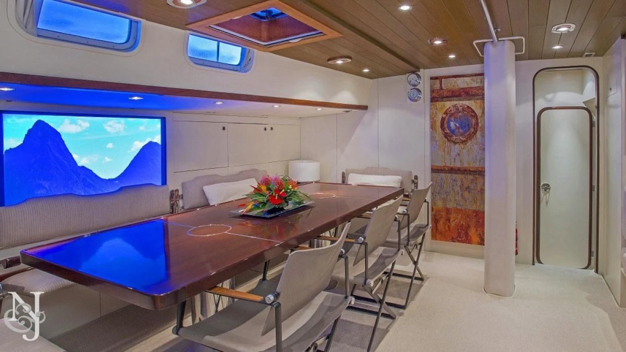 a room with a table and chairs aboard WISDOM Yacht for Sale
