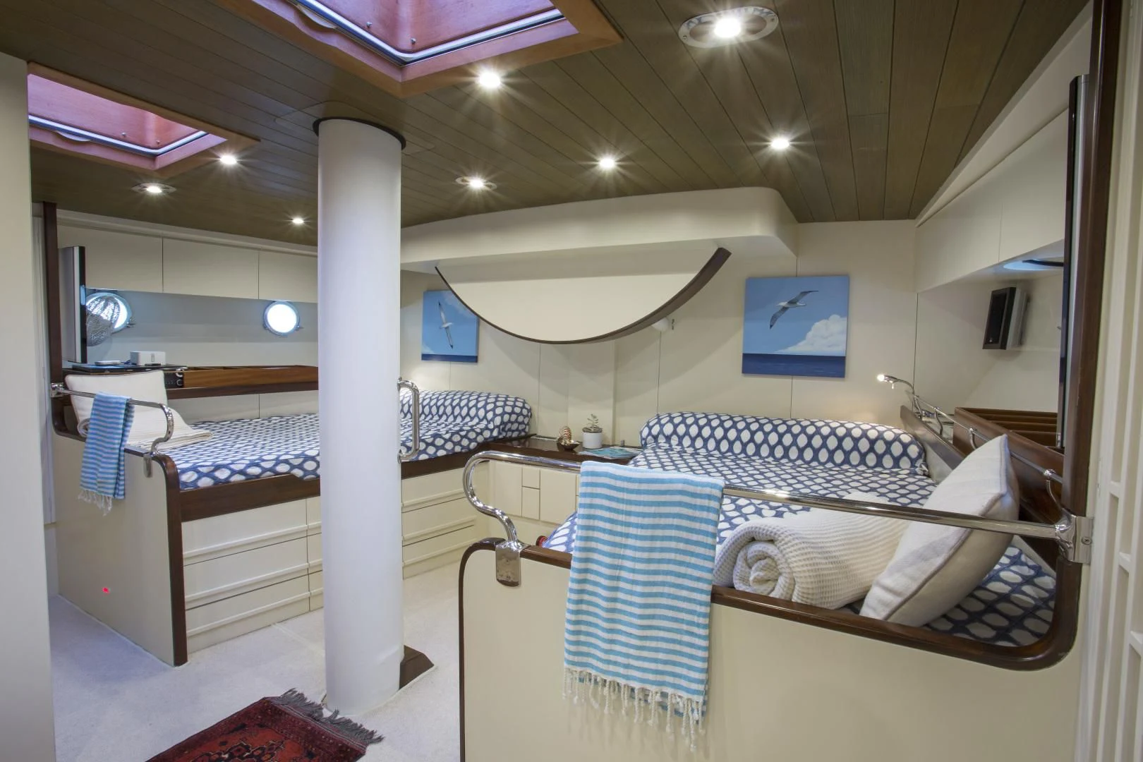 a room with beds and a table aboard WISDOM Yacht for Sale