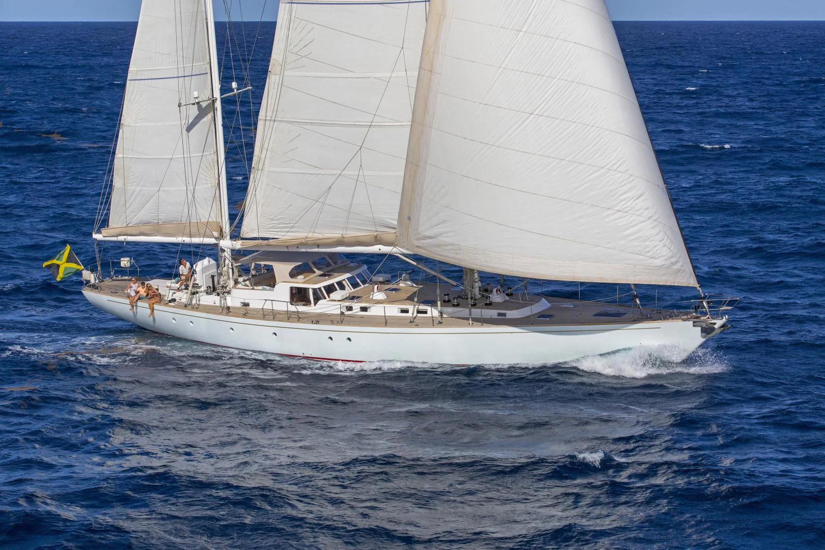 a white sailboat on the water aboard WISDOM Yacht for Sale
